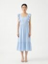 Mannequin portant la robe mi-longue bleu clair 'Shadow' avec encolure carrée, bretelles à volants et jupe froncée, de la marque Divine Dress.