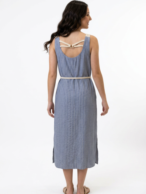 Mannequin souriante portant une robe 'blue breeze' midi bleue à fines rayures blanches, avec poches, fentes latérales et détails en corde, de la marque Divine Dress.