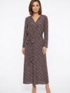 Mannequin portant la robe longue marron à motif géométrique 'Geometric Grace', avec col en V, manches longues et ceinture à nouer, de la marque Divine Dress.